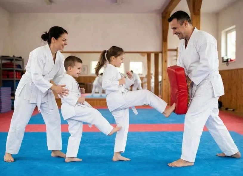 Family karate training basics with instructor-led kicking practice